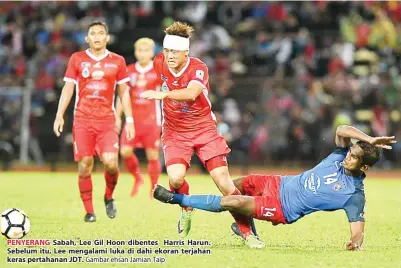  ?? Gambar ehsan Jamian Taip ?? PENYERANG Sabah, Lee Gil Hoon dibentes Harris Harun. Sebelum itu, Lee mengalami luka di dahi ekoran terjahan keras pertahanan JDT.