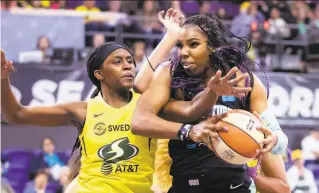  ?? Bettina Hansen / The Seattle Times ?? New York forward Reshanda Gray pulls down a rebound against Seattle forward Crystal Langhorne in Seattle. The Liberty won the game 8483 in Seattle.