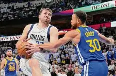  ?? Tony Gutierrez / Associated Press ?? Luka Doncic, left, is fouled by Golden State’s Stephen Curry during Game 4 of the West finals. Dallas won, 119-109 to force Game 5. For a full story, go to http://timesunion.com/sports.