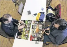  ?? COLIN MACLEAN/JOURNAL PIONEER ?? Sebastian Bilodeau, left, and Cole Dowdle, right, play a game of Magic: The Gathering in Bilodeau’s new store Next Level Games and Collectibl­es.