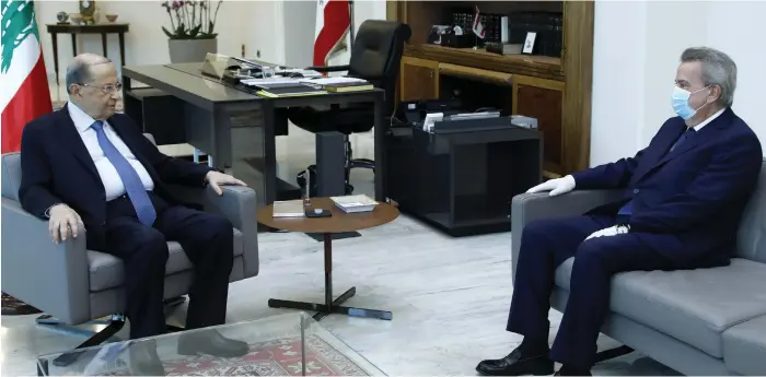  ?? AFP ?? President Michel Aoun, left, pictured during a meeting with central bank chief Riad Salameh. Mr Salameh is reportedly under political pressure to explain his policies after Lebanon lost an extra $7 billion since the start of the year amid claims that liquidity in its banking system is running out