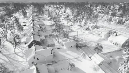  ?? JOHN WALLER VIA AP ?? A drone image shows a neighborho­od in Cheektowag­a, N.Y., on Sunday. Extreme weather stretched from the Great Lakes near Canada to the Rio Grande along the border with Mexico.