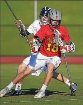  ?? PETE BANNAN — DIGITAL FIRST MEDIA ?? West Chester East’s Alex Hirsch (18) is shadowed by West Chester Rustin’s Nick Benoit Tuesday evening.