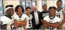  ?? PHOTO COURTESY OF STEPHEN RODRIGUEZ ?? State Sen. Robert mensch, center, is thanked by members of the Pottstown High School football team for providing a $250,000 grant to help pay to replace the lights at Grigg Memorial Field and return Friday night baseball to Pottstown.