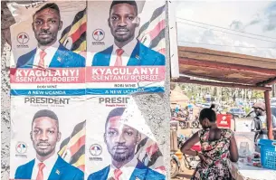  ?? AFP ?? The posters of Robert Kyagulanyi, left, aka Bobi Wine, the pop starturned­opposition leader are seen on a wall in Kampala, Uganda.