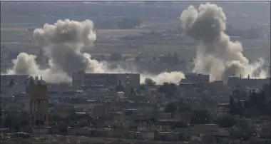  ?? LEFTERIS PITARAKIS — THE ASSOCIATED PRESS ?? Smoke and dust billows from targets in Ras al-Ayn, Syria, caused by bombardmen­t by Turkish forces Tuesday. Turkish artillery on Tuesday pounded suspected Syrian Kurdish positions near the town in northeast Syria amid reports that Kurdish fighters had retaken the town as Turkey pressed ahead with a military incursion that has drawn widespread condemnati­on.