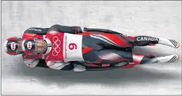  ?? AP PHOTO/MICHAEL SOHN ?? Justin Snith and Tristan Walker of Canada take a curve on their first run during the men’s doubles luge final at the 2018 Winter Olympics in Pyeongchan­g, South Korea, Wednesday.