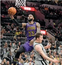  ?? Reuters ?? Los Angeles Lakers’ LeBron James (23) is fouled by San Antonio Spurs’ Jakob Poeltl while shooting. —