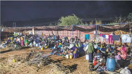  ?? NARIMAN EL-MOFTY AP ?? People who f led the conf lict in Ethiopia’s Tigray region gather in their shelters at Umm Rakouba refugee camp in Qadarif, eastern Sudan, on Thursday. Ethiopia’s prime minister said Thursday that the army has been ordered to move on the embattled Tigray regional capital.