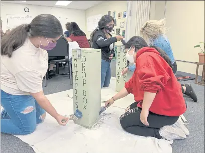  ?? PHOTOS BY LILY ADKINS ?? Members of the Ukiah Valley Youth Leadership Coalition finish painting their Whippet disposal boxes at a meeting.