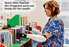  ?? ?? Story time: Teacher Mrs Tregenna sorts out books for her pupils