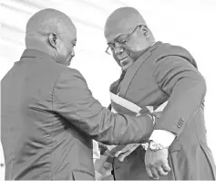  ??  ?? File photo shows Tshisekedi receiving the presidenti­al sash from the outgoing President Joseph Kabila during the inaugurati­on ceremony. — Reuters photo