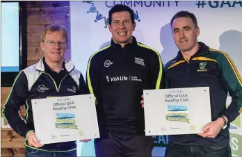  ??  ?? Wicklow representa­tives, Paul Sweeney, Bray Emmets GAA, left, and Declan Byrne, Annacurra GAA, with their Official Healthy Club Awards alongside Seán Cavanagh.