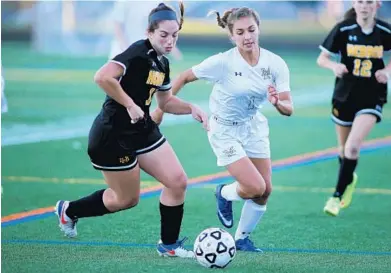  ?? DANIEL KUCIN JR./BALTIMORE SUN MEDIA GROUP ?? Mount Hebron senior defender Sam Goodwin, left, challenges Marriotts Ridge sophomore midfielder Victoria Hensh for the ball. The Vikings, who led 1-0 at halftime, added two goals in the second half for a 3-1 victory.