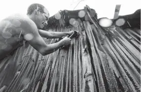  ??  ?? A resident makes repairs to his hurricaned­amaged home in the aftermath of Hurricane Willa in Escuinapa, Mexico. There were no immediate reports of deaths or missing people, but Willa's strong winds knocked out power and left some damage. Marco Ugarte / AP