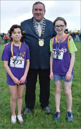  ??  ?? Grace Kelly and Emma McCarthy, medal winners in the Under-11 girls’ race, with Cllr. Keith Doyle, Chairman of Wexford County Council.