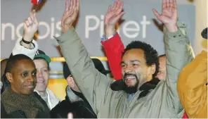  ?? (John Schults/Reuters) ?? DIEUDONNE M’BALA M’BALA raises hands with fans near a Paris theater, which canceled his show in February 2004 fearing his performanc­e would spark protests by anti-racist and Jewish groups.