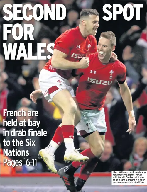  ??  ?? Liam Williams, right, celebrates his early try against France with Gareth Davies but it was to be a rare highlight in a dour encounter won 14-13 by Wales