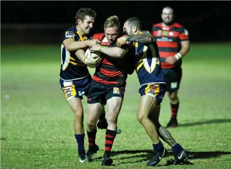  ?? Photos: Kevin Farmer ?? BREAKING FREE: Highfields players Jarrod Lee (left) and Zane Miller try to stop Valleys’ Nick Sargent during the Eagles 30-24 win at Kuhls Rd on Saturday night.