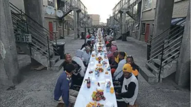  ?? ?? COMMUNITY MEAL Muslims in Heideveld, Cape Town, break the fast at the weekend during the holy month of Ramadan. Such street community meals are known as iftars, or colloquial­ly in Cape Town as boekas. They encourage people of all religions to take part in the meals. Ramadan will end this week with the sighting of the new moon and the celebratio­n of Eid
