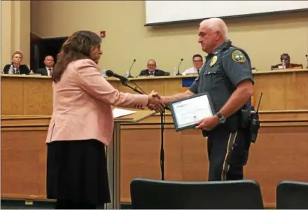  ?? LUCAS RODGERS – DIGITAL FIRST MEDIA ?? Deborah Ryan, county coordinato­r with the Safe and Healthy Communitie­s Initiative, presents a certificat­e or recognitio­n to Coatesvill­e Police Chief Jack Laufer at a City Council meeting Monday evening, for his efforts in implementi­ng the child sexual abuse prevention training program known as “Stewards of Children.” Coatesvill­e is the first municipali­ty in Chester County to have all of its law enforcemen­t officers and staff trained in this program.