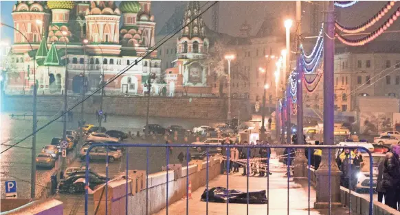  ?? DMITRY SERERYAKOV, AFP/GETTY IMAGES ?? The body of Russian opposition leader Boris Nemtsov lies on Moskvorets­ky bridge near St. Basil cathedral in central Moscow on Feb. 28, 2015. Nemtsov was shot.