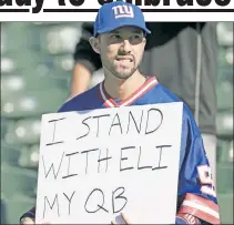  ?? N.Y. Post: Charles Wenzelberg ?? STAND BY YOUR MANN’: A fan holds up a sign in support of Eli Manning during the Giants’ 24-17 loss to the Raiders on Sunday.