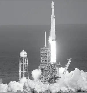  ?? JOHN RAOUX/THE ASSOCIATED PRESS ?? A Falcon 9 SpaceX heavy rocket lifts off Tuesday from pad 39A at the Kennedy Space Center in Cape Canaveral, Fla. The Falcon Heavy, has three first-stage boosters, strapped together with 27 engines in all.