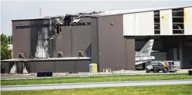  ?? Shaban Athuman / Dallas Morning News ?? Damage is seen to a hangar at Addison Airport after a plane crash Sunday.