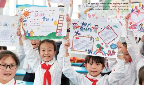  ?? ?? As part of a school-wide activity in 2021, students in Lianyungan­g, Jiangsu province, make posters about learning Putonghua