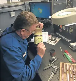  ??  ?? Top: an Aerospace Tooling Ltd technician scrutinise­s a part.