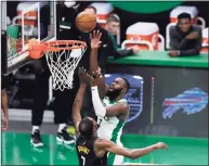  ?? Omar Rawlings / Getty Images ?? The Celtics’ Jaylen Brown drives to the basket over the Nets’ Kevin Durant during the second quarter on Friday in Boston.