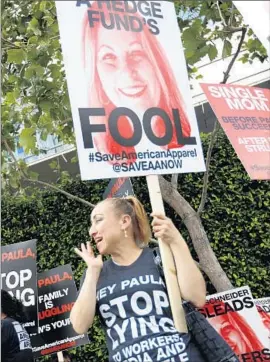  ?? Barbara Davidson
Los Angeles Times ?? MARIA SALGADO joins American Apparel workers at a protest Friday outside a downtown L.A. hotel where Chief Executive Paula Schneider was speaking.