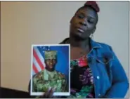  ?? JAY REEVES—ASSOCIATED PRESS ?? In this Nov. 27, 2018, file frame from video, April Pipkins holds a photograph of her deceased son, Emantic “EJ” Bradford Jr., during an interview in Birmingham, Ala. Bradford, who was licensed to carry a gun, was killed Thanksgivi­ng night by an officer responding to a report of gunfire at a shopping mall in Hoover, Ala. The recent shootings of Bradford Jr. and Jemel Roberson amplified long-held worries that bad things can happen when a black man is seen with a gun.