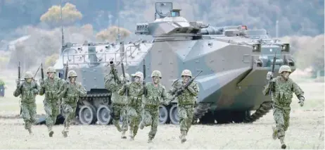  ??  ?? Soldiers of Japanese Ground Self-defence Force’s Amphibious Rapid Deployment Brigade take part in a drill at JGSDF’S Camp Ainoura in Sasebo, on the southwest island of Kyushu, Japan on Saturday. — Reuters