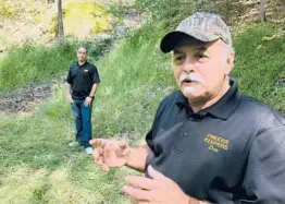  ?? MICHAEL RUBINKAM/2018 ?? Treasure hunters Dennis Parada and his son, Kem, stand at the site of the FBI’s dig for gold in Dents Run, Pennsylvan­ia. The FBI said it did not find anything.