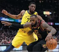  ?? AP PHOTO/TONY DEJAK ?? Cleveland Cavaliers’ LeBron James, right, drives against Indiana Pacers’ Thaddeus Young during the first half of Game 2 of an NBA basketball first-round playoff series Wednesday in Cleveland.