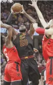  ?? AP PHOTO ?? HEAVY TRAFFIC: LeBron James scores during last night’s Game 3 between the Cavaliers and Raptors in Cleveland.