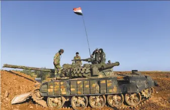  ?? George Ourfalian / AFP / Getty Images ?? Syrian government soldiers patrol Saturday near the northern city of Manbij. With the help of Russia and Iran, President Bashar Assad has gradually reclaimed control across the country.