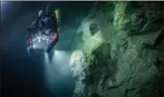  ?? KRZYSZTOF STARNAWSKI OF THE KRZYSZTOF STARNAWSKI EXPEDITION VIA AP ?? In this underwater photo taken in the flooded Hranicka Abyss, Czech Republic, Polish explorer Krzysztof Starnawski is seen examining the limestone crevasse and preparing for a 2016 expedition to measure it depths. On Starnawski and his Polish-Czech...