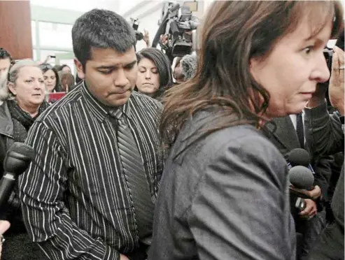  ??  ?? Concluded: Munoz following his lawyers as he leaves the courtroom, after a judge ruled that his wife and unborn child could be removed from life support. — Photos MCT