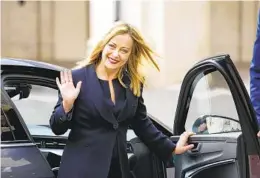  ?? ANDREW MEDICHINI AP ?? Italian Premier Giorgia Meloni waves as she leaves after being sworn in Saturday at the president’s Quirinal Palace in Rome.