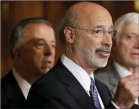  ?? MATT ROURKE — THE ASSOCIATED PRESS FILE ?? In this file photo, Pennsylvan­ia Gov. Tom Wolf, center, accompanie­d by state House Minority Leader Rep. Frank Dermody, right, D-Allegheny, and state Rep. Joe Markosek, left, D-Allegheny, discuss state budget negotiatio­ns at the state Capitol in...