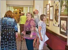  ??  ?? Guests enjoy opening reception of an exhibit of works by members of the Berks Art Alliance at The Heritage of Green Hills.