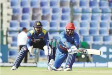  ?? Ahmed Kutty/Gulf News ?? Afghanista­n’s Mohammad Shahzad playing a reverse sweep against Sri Lanka at Zayed Stadium in Abu Dhabi yesterday.