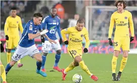  ?? AFP ?? Paris Saint-Germain’s forward Kylian Mbappe (second right) vies for the ball with Strasbourg’s midfielder Jonas Martin (left) during their French league football match at the Meinau Stadium in Strasbourg, eastern France, on Saturday. PSG lost 1-2. —