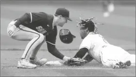  ?? RON SCHWANE/AP ?? CLEVELAND GUARDIANS’ JOSÉ RAMÍREZ (RIGHT) steals second base as San Diego Padres’ Jake Cronenwort­h attempts is late with tag during the first inning in the first game of a doublehead­er on Wednesday in Cleveland.