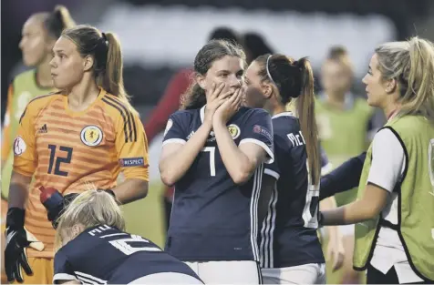  ??  ?? 0 Kirstie Mcintosh, centre, cuts a dejected figure after Scotland U19s’ hopes of earning a draw were dashed by a late French strike.