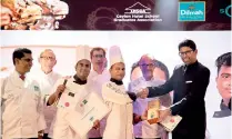  ??  ?? Winners of Best Tea-inspired Dish receive their award from Dilmah Tea Director Malik J. Fernando