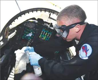  ?? Courtesy of the United States Air Force ?? Staff Sgt. Brandon Green, 99th Aircraft Maintenanc­e Unit dedicated crew chief, sprays disinfecta­nt liquid on a rag to sanitize a U-2 Dragon Lady’s cockpit Monday at Beale Air Force Base. The cockpits on Beale’s fleet of U-2s will be sanitized on a regular basis to prevent the spread of COVID-19.